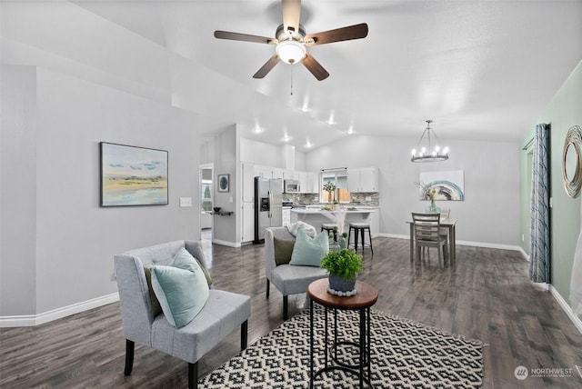 living room featuring ceiling fan with notable chandelier, vaulted ceiling, and dark hardwood / wood-style floors