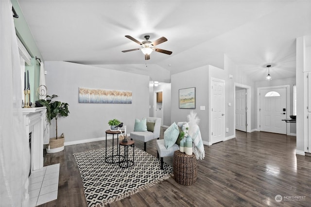 living room featuring ceiling fan, vaulted ceiling, a wealth of natural light, and dark hardwood / wood-style floors