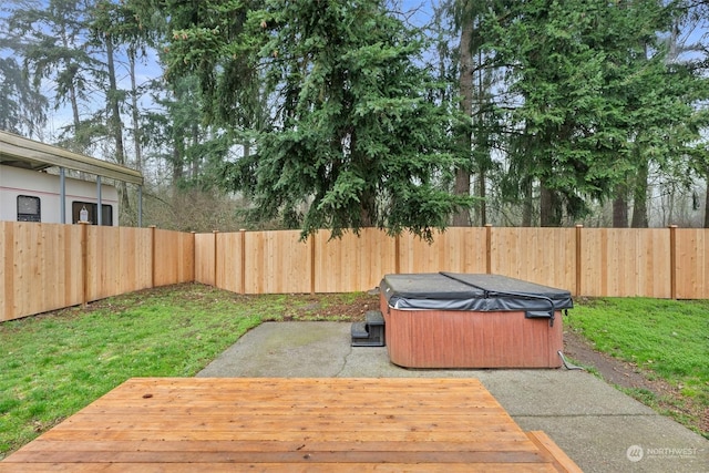 wooden deck with a hot tub and a yard