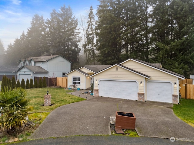 view of front of property featuring a front lawn and a garage