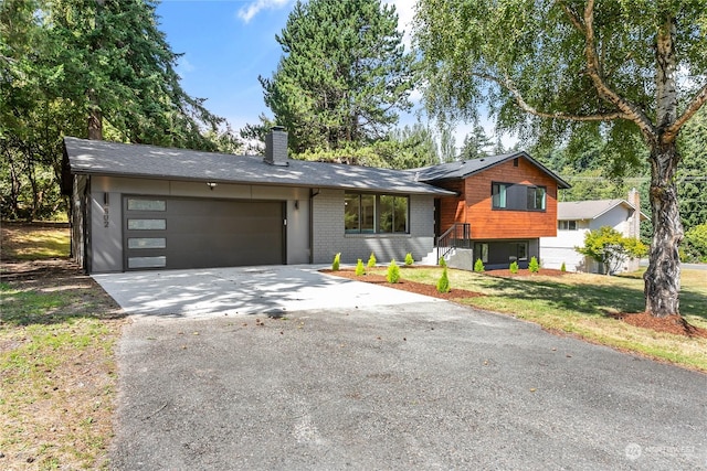 view of front of property with a front lawn and a garage