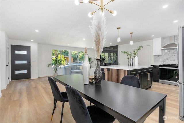 dining room featuring a chandelier and light wood-type flooring