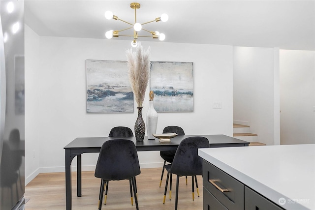 dining room featuring light hardwood / wood-style flooring and a notable chandelier