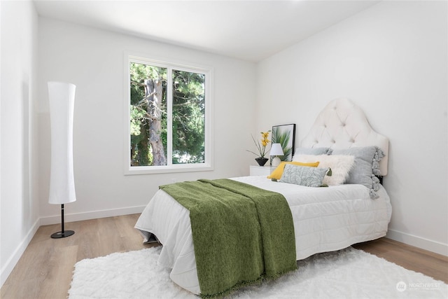 bedroom with hardwood / wood-style floors