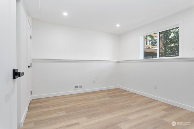 unfurnished room with light hardwood / wood-style flooring