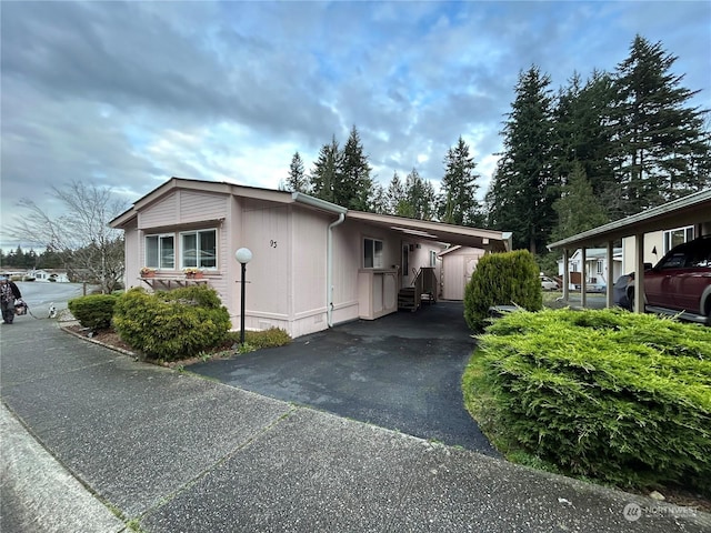 view of side of home with a carport