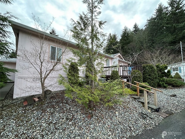 view of side of home with a wooden deck