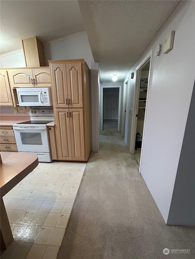 kitchen featuring light carpet, light brown cabinetry, white appliances, a textured ceiling, and lofted ceiling