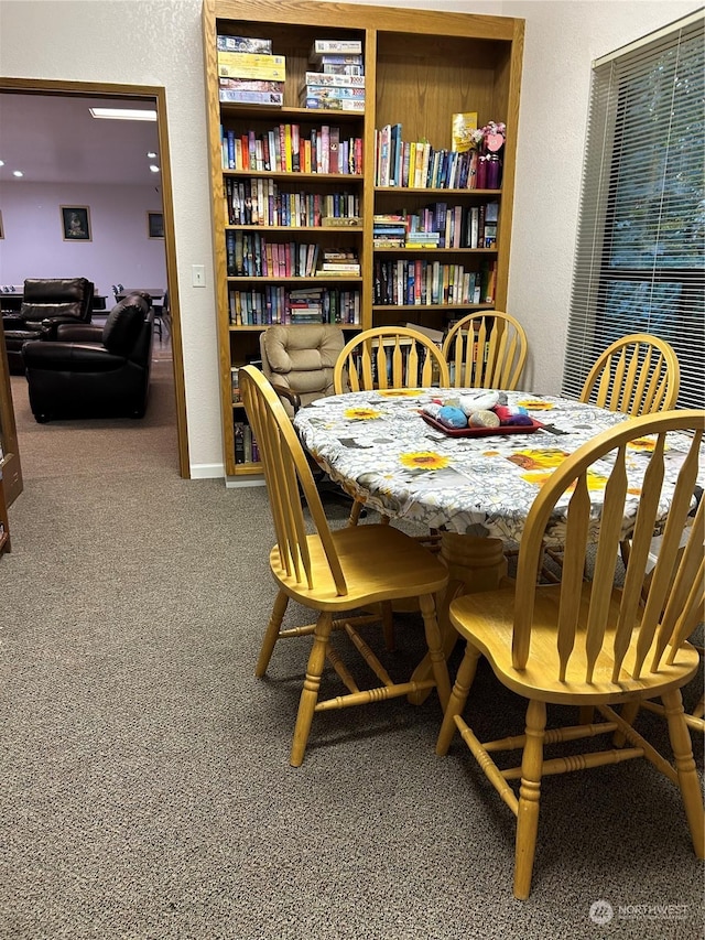 dining area with carpet and built in shelves