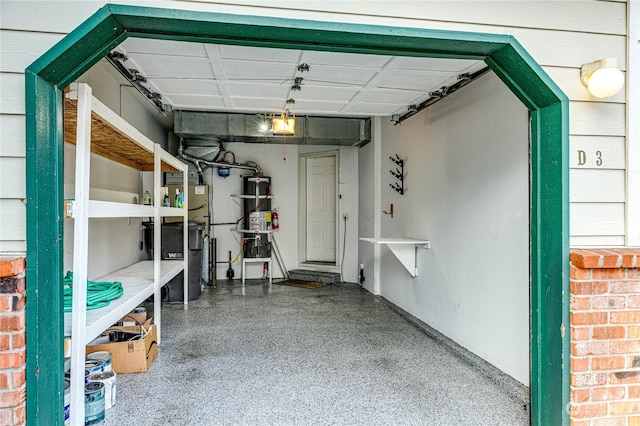 garage featuring a garage door opener and water heater