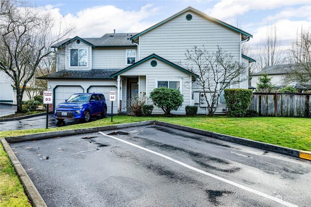 view of front property with a garage and a front lawn