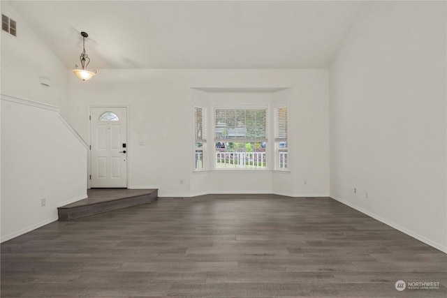 entrance foyer with dark hardwood / wood-style flooring and lofted ceiling