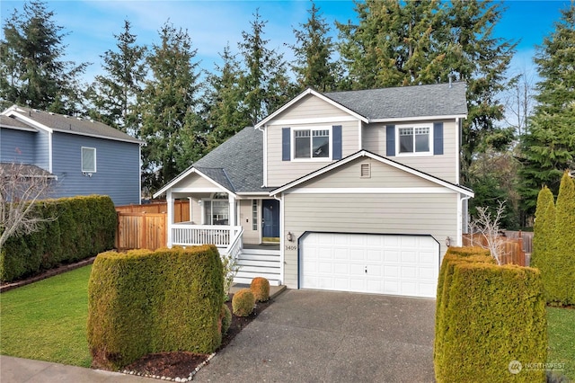 front of property with covered porch and a garage