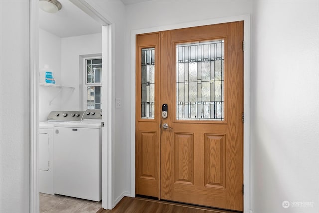 doorway with light wood-type flooring and independent washer and dryer