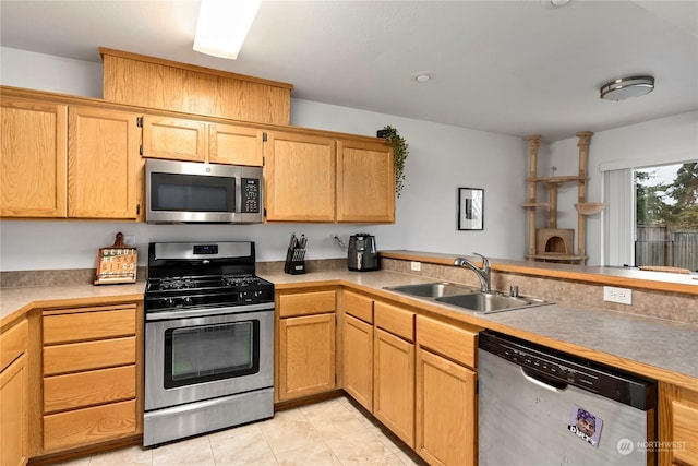 kitchen featuring light tile patterned floors, stainless steel appliances, and sink