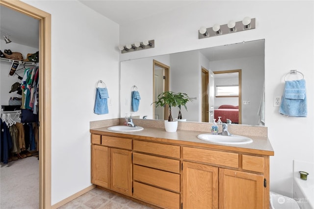 bathroom featuring tile patterned flooring and vanity