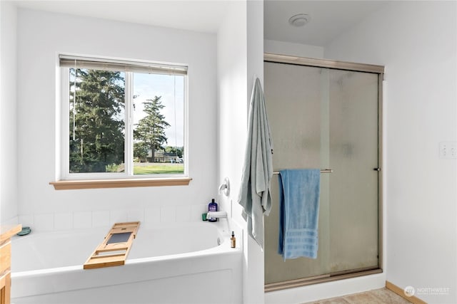 bathroom with independent shower and bath and a wealth of natural light