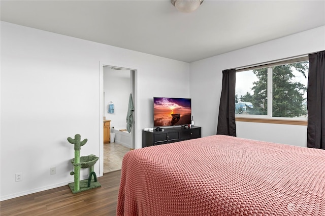 bedroom with dark hardwood / wood-style floors