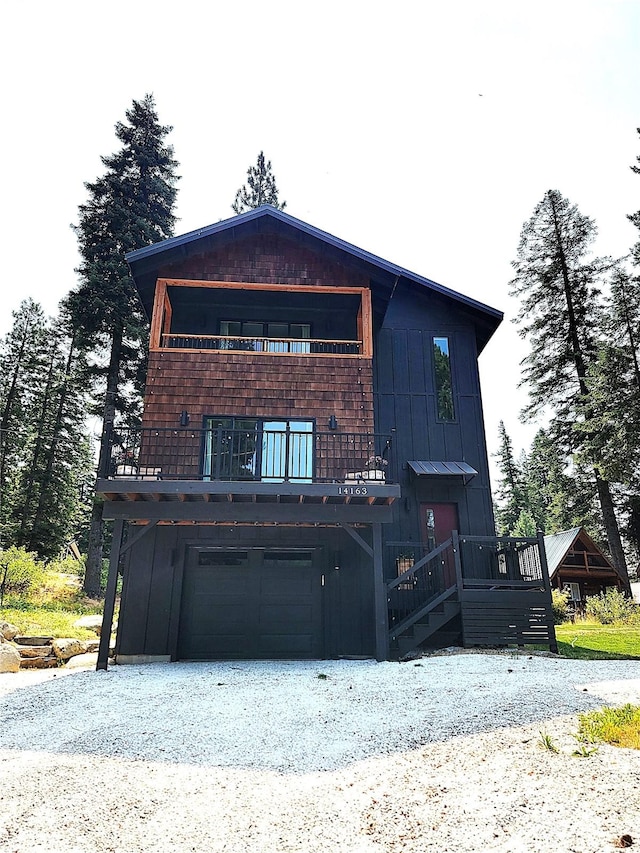 view of front facade with a wooden deck and a garage