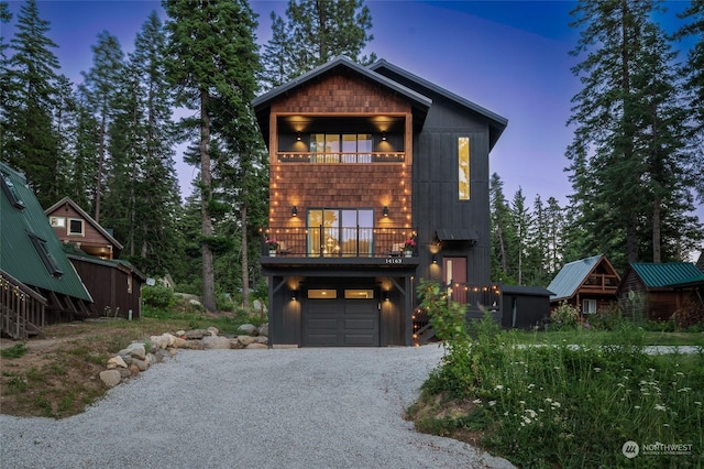 view of front of house with a garage and a balcony