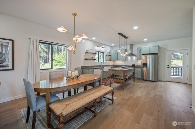 dining area featuring plenty of natural light and light hardwood / wood-style flooring