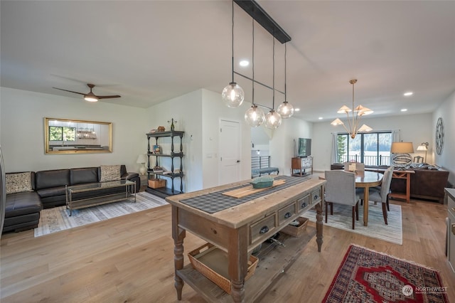 dining space featuring ceiling fan and light wood-type flooring