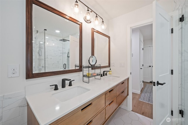 bathroom with tile patterned flooring, vanity, and walk in shower