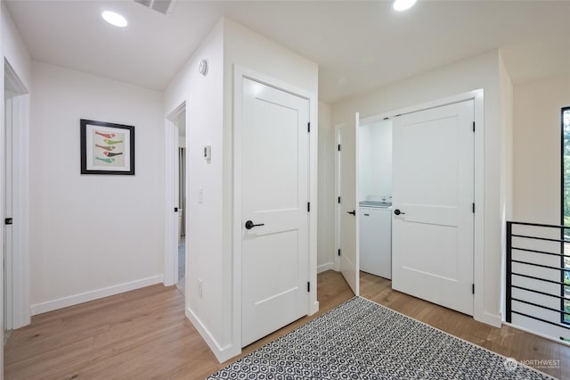 hall with light hardwood / wood-style floors