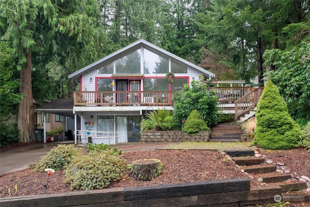 view of front of home featuring a carport and a wooden deck