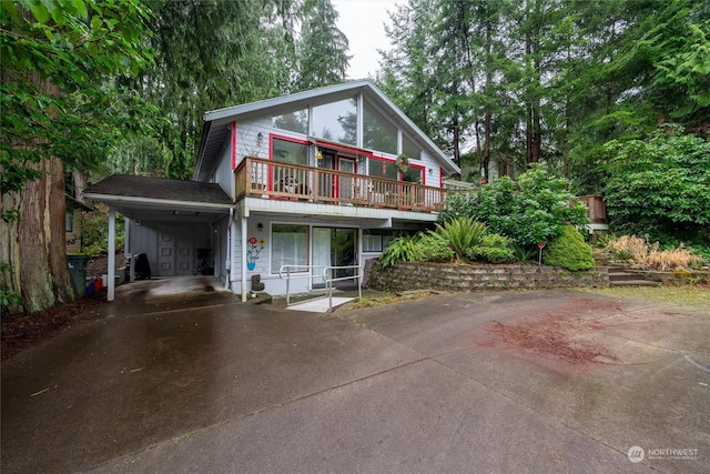 front of property featuring a balcony and a carport