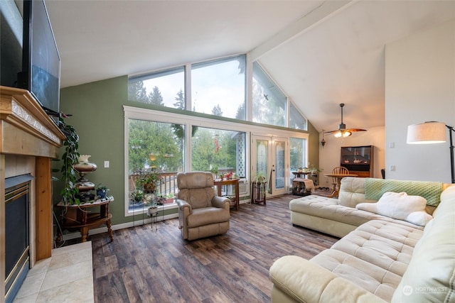 living room with french doors, ceiling fan, a fireplace, beam ceiling, and wood-type flooring