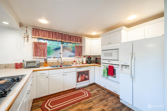 kitchen featuring white cabinets, dark hardwood / wood-style flooring, white appliances, and sink