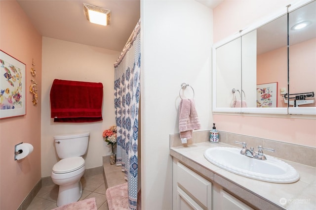 bathroom with tile patterned flooring, vanity, and toilet