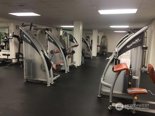 workout area with a paneled ceiling