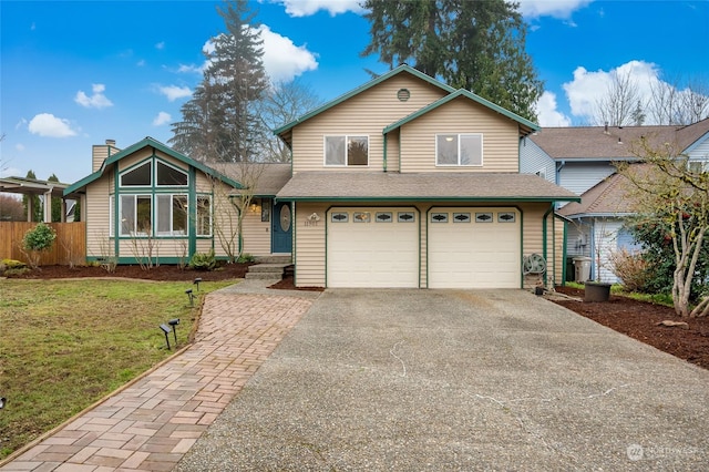 view of front property featuring a front lawn and a garage