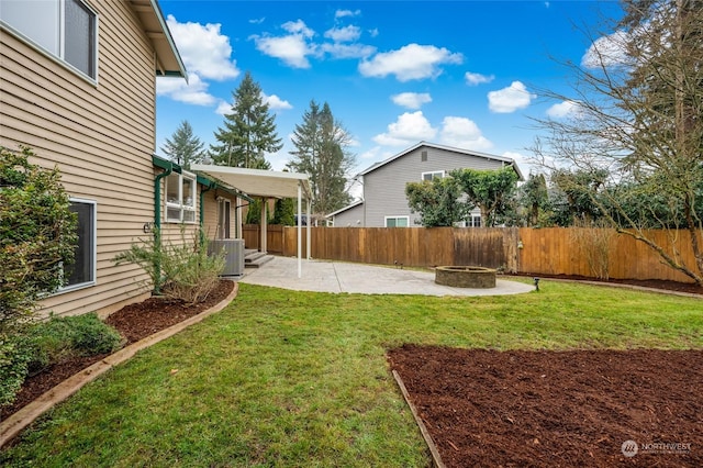 view of yard with cooling unit, a fire pit, and a patio area