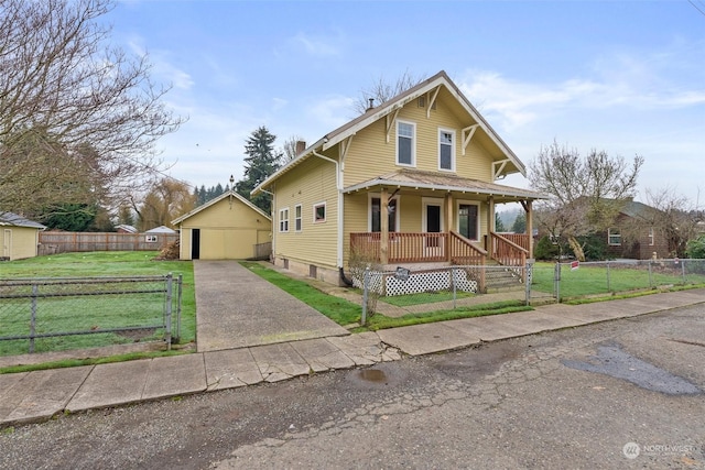 view of front of home featuring covered porch, a garage, an outdoor structure, and a front yard