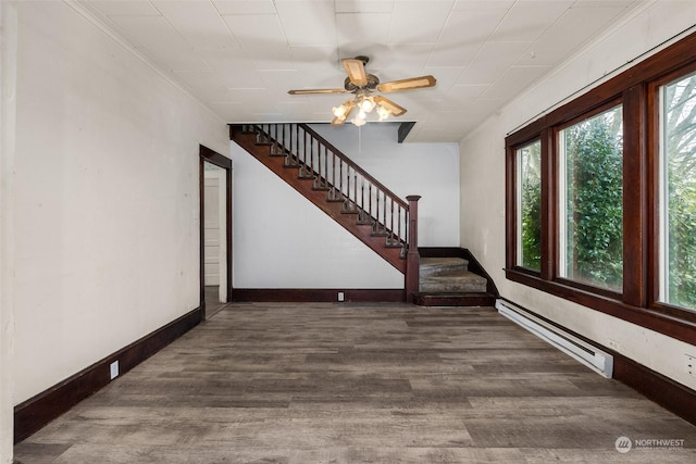 interior space featuring ceiling fan, dark wood-type flooring, and a baseboard radiator