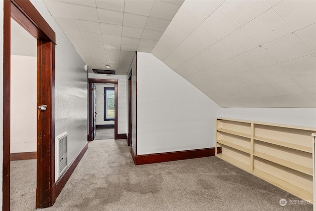 additional living space with carpet flooring and lofted ceiling