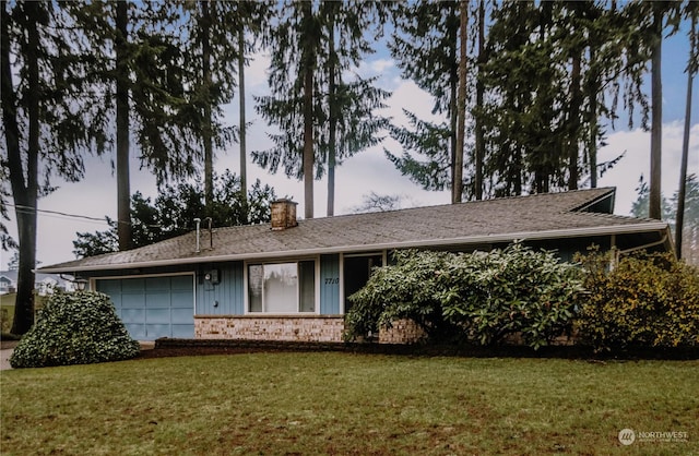 ranch-style home with a lawn and a garage