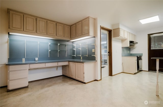 kitchen with light brown cabinetry, built in desk, tasteful backsplash, and range