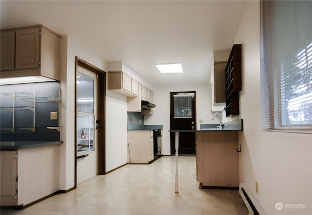 kitchen featuring a baseboard heating unit and sink