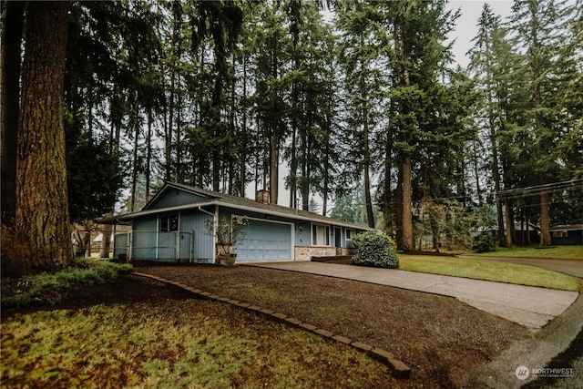 ranch-style home with a garage and a front yard