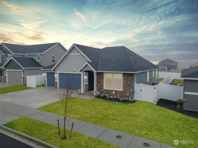 view of front of home with a lawn and a garage