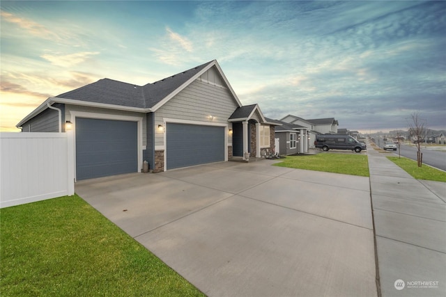 view of front of property featuring a garage and a yard