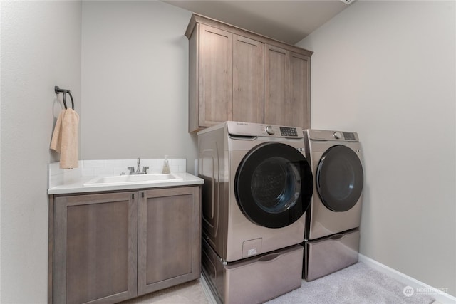 laundry area with washer and dryer, sink, light colored carpet, and cabinets