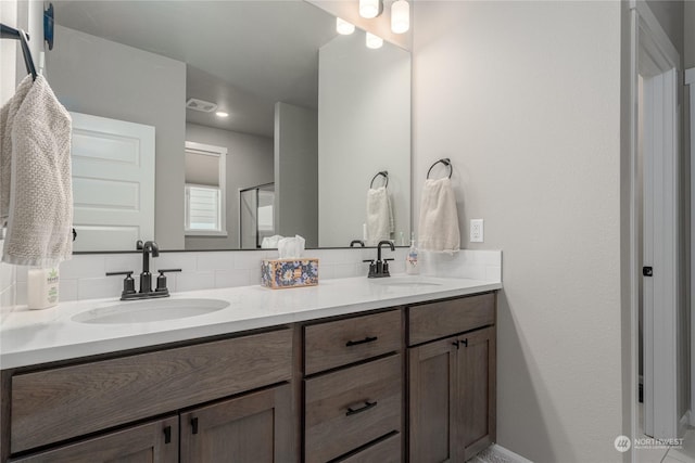 bathroom featuring vanity and backsplash