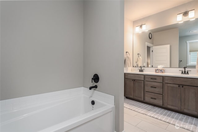 bathroom with vanity, tile patterned flooring, and a tub