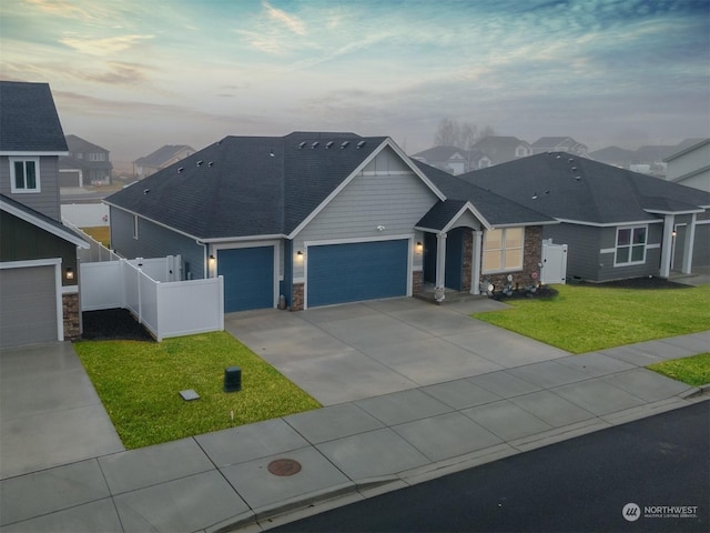 view of front of home featuring a garage and a lawn