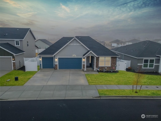 view of front of house featuring a garage and a lawn